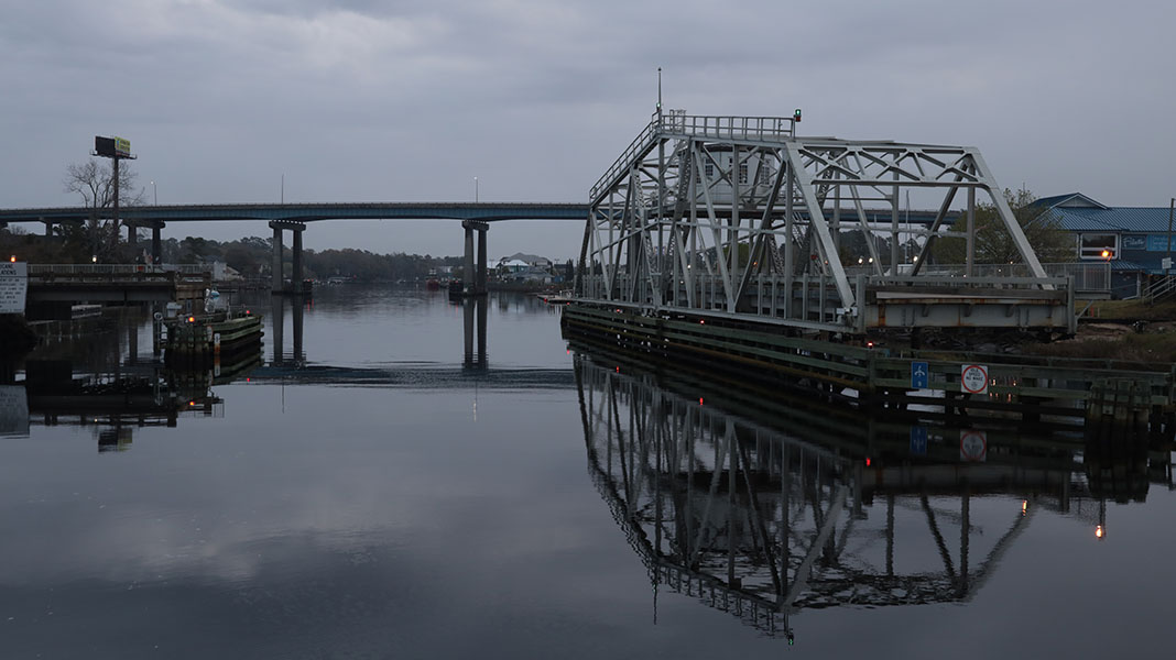 Swing truss bridge over a small body of water.